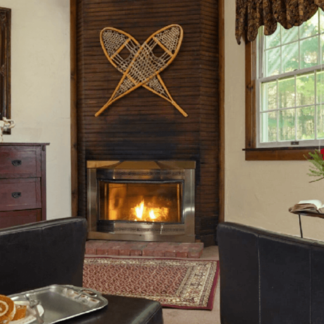 Cozy suite featuring a fireplace and decorative snowshoes on the wall.