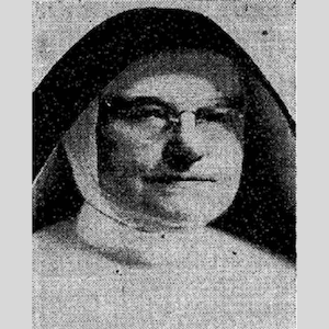 A black-and-white portrait of a woman in a nun's habit, wearing glasses.