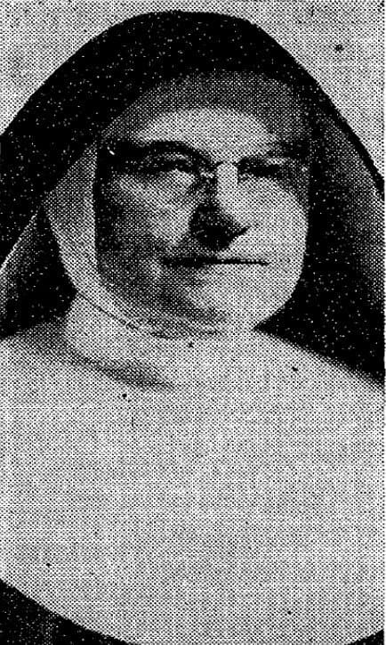 A portrait of a woman wearing a nun's habit and glasses.