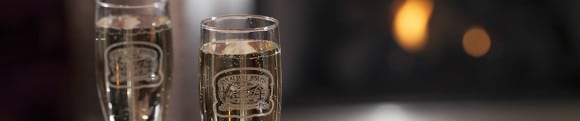 Two champagne glasses with the Inn at Lake Joseph logo Two champagne glasses with the Inn at Lake Joseph logo